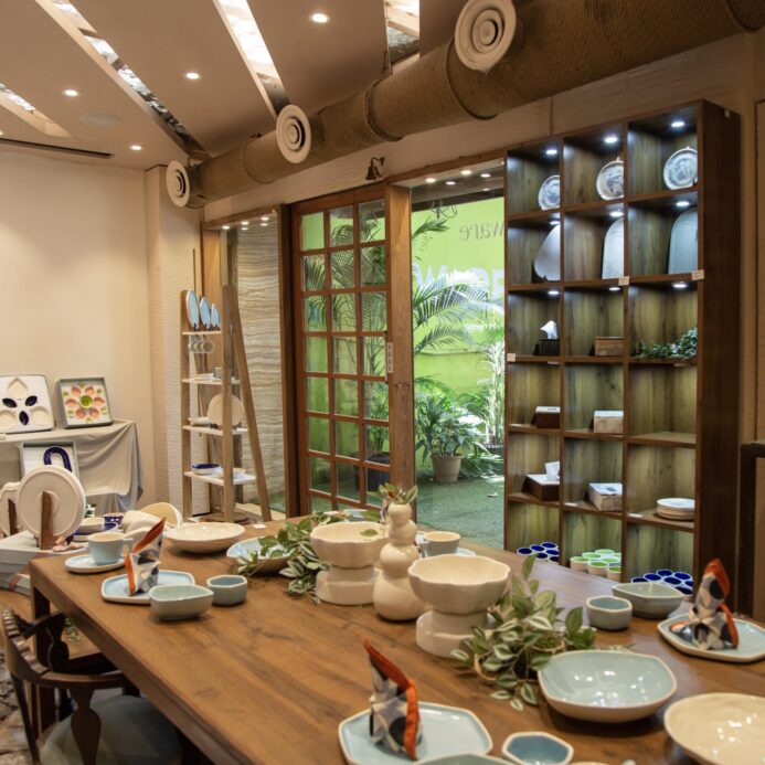 Elegant dinnerware set displayed on a wooden table at Ware Innovations.